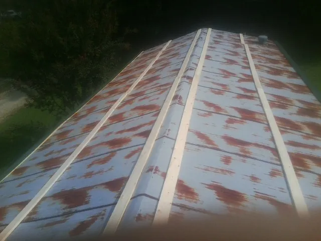 Rusted metal roof panels with new wood purlins before replacement — Storm Damage Roof Repair in Fort Hood by Roofing Brothers